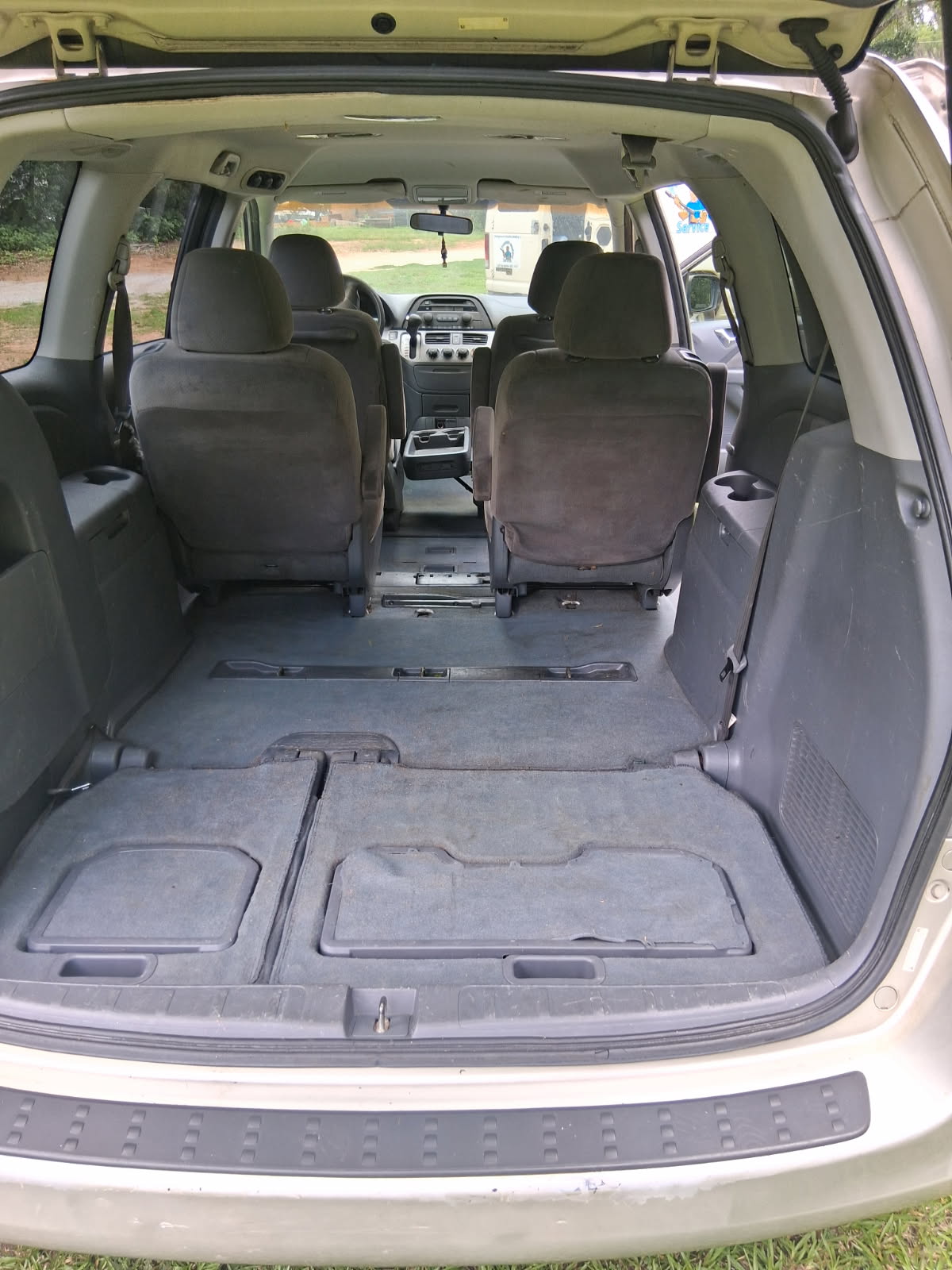 Clean minivan interior after detailing — vacuumed carpets, wiped surfaces, ready to haul